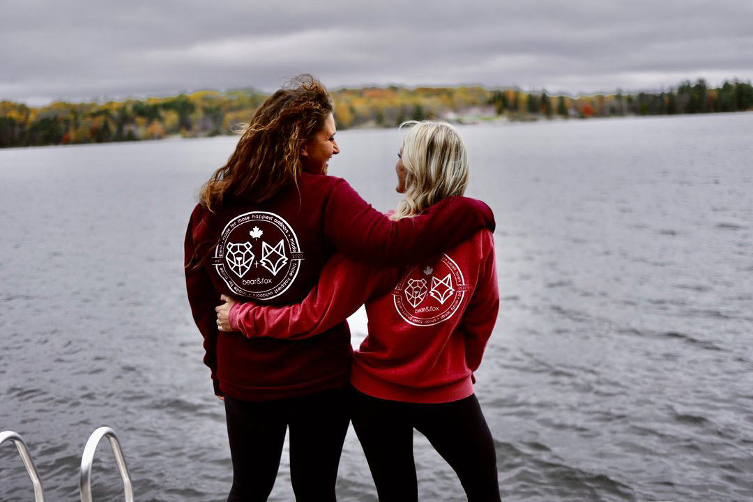 two canadian women in bear and fox crewnecks in northern ontario