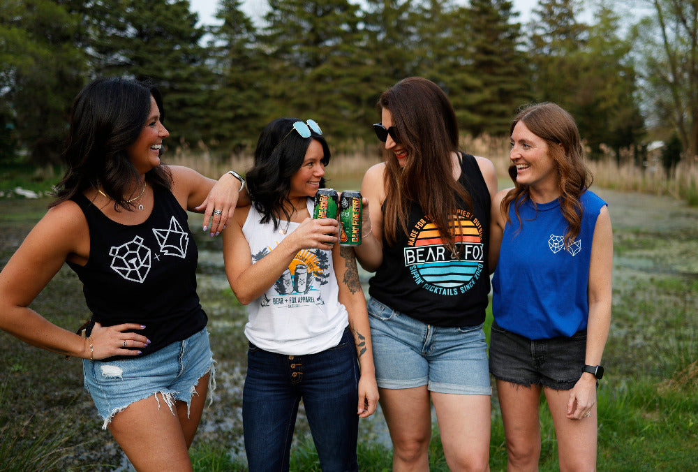 four friends in bear and fox apparel tank tops at the cottage