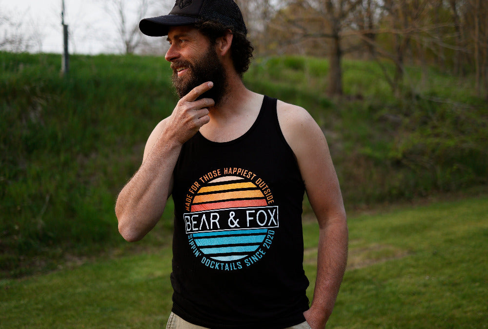 bearded man in sippin' docktails tank top outdoors