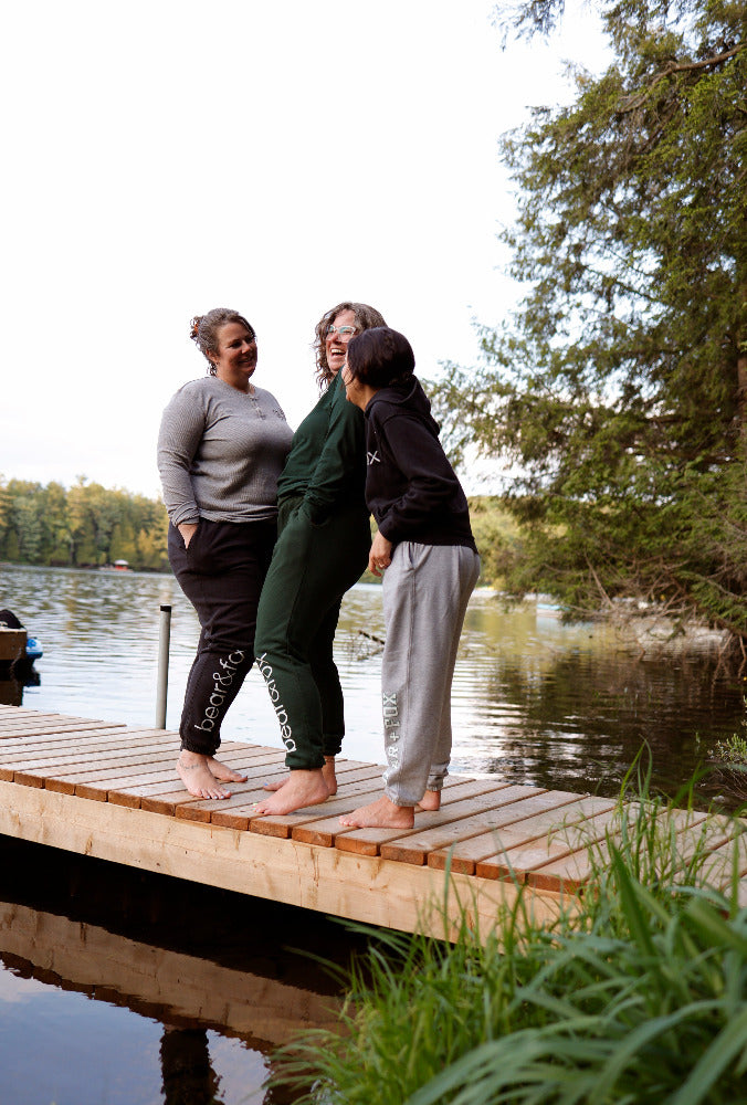 three friends on the dock in their cozy sweatpants 