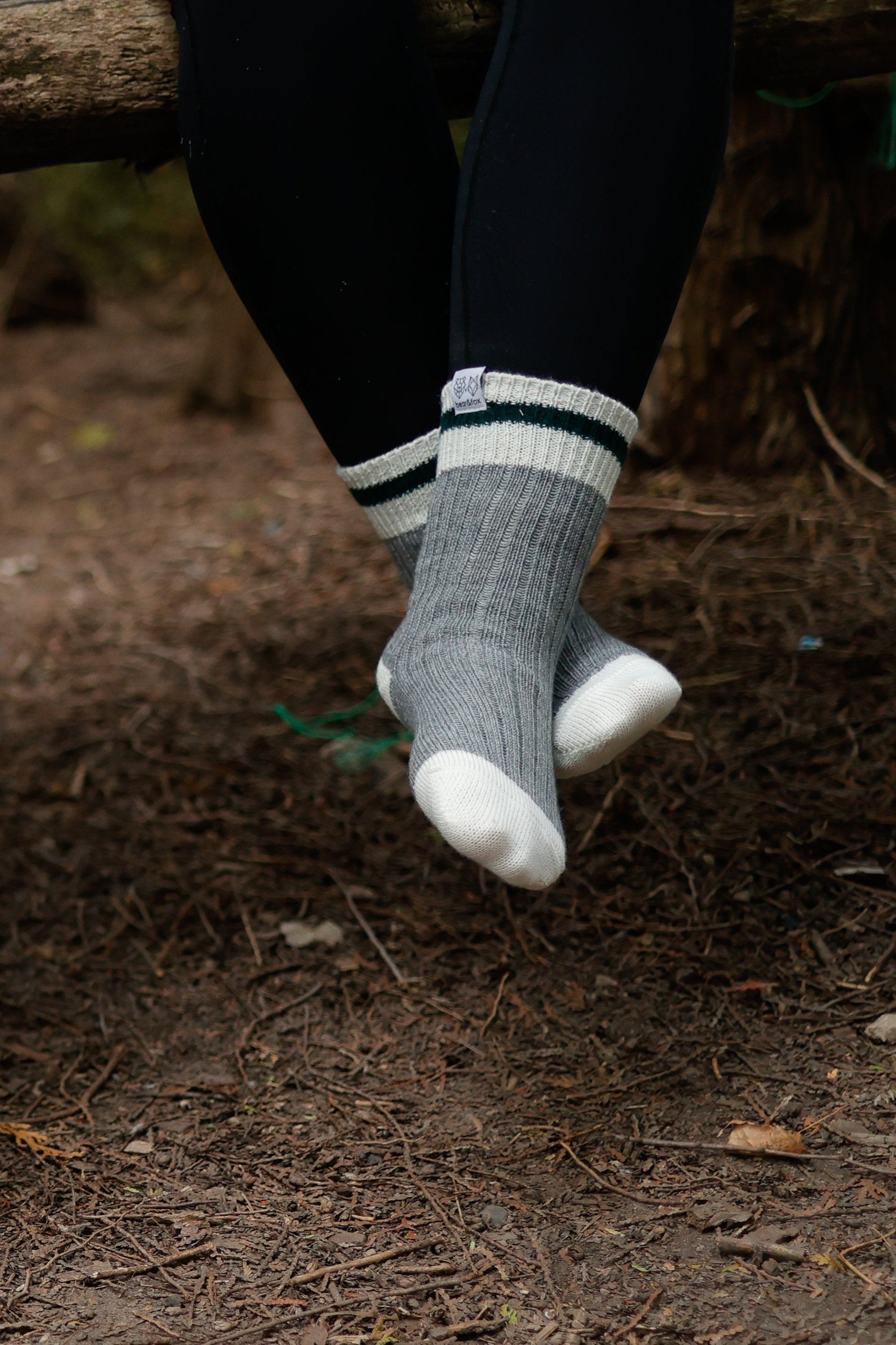 canadian made wool socks with both red and green stripes across a classic grey wool sock