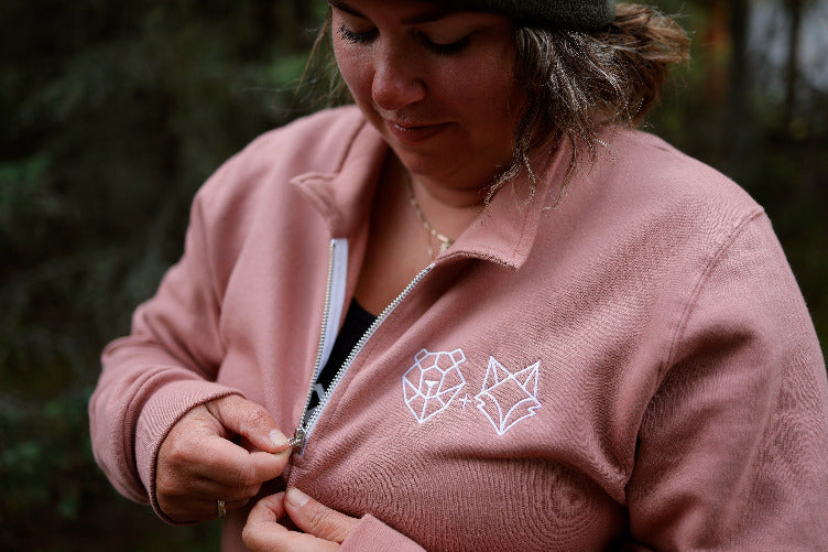 canadian woman zipping up 1/4 zip dusty rose in northern ontario