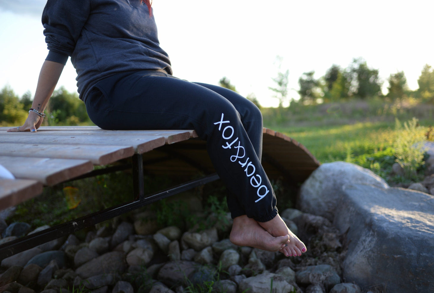 Bear and Fox Apparel Terry Fox Jogger sweatpant girl sitting on bridge outside at the cottage